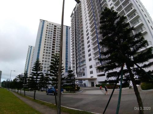 a large apartment building with trees in front of it at Rm Staycation TaalView Smdc in Tagaytay