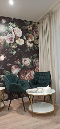 a living room with a flower mural on the wall at Citylife Boutique Hotel in Kharkiv