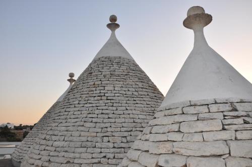 two spires of a building with snow on them at Trulli Magravì - Apparthotel in Alberobello