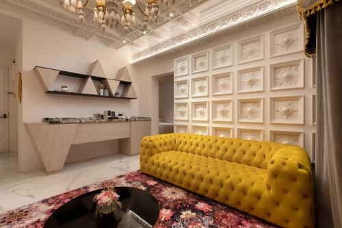 a living room with a yellow couch and a table at arte by Thomas Chan in Kuala Lumpur