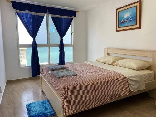 Un dormitorio con una cama y una ventana grande en Kattyapartament 1103vista al mar, en Salinas