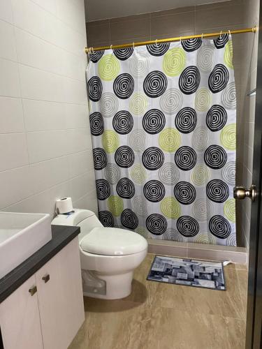 Un baño con inodoro y cortina de ducha en Kattyapartament 1103vista al mar, en Salinas