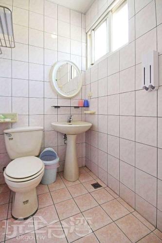 a bathroom with a toilet and a sink at Dahan Homestay in Yuchi