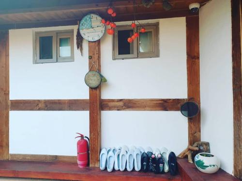 a house with two windows and a clock on the wall at Hanok Dream in Jeonju