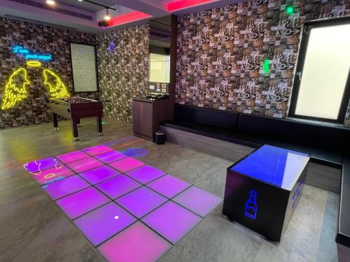 a room with a ping pong table and purple lights at Yosemite Motel - Chunghua Branch in Taichung