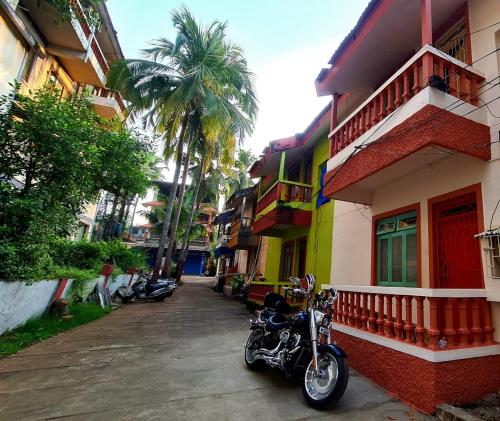 a motorcycle parked on a street next to a building at Ruby Apartments 4 in Calangute
