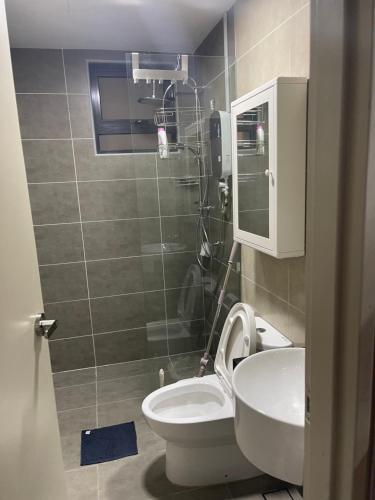 a small bathroom with a toilet and a sink at Studio Unit@ Ampang Ukay in Ampang