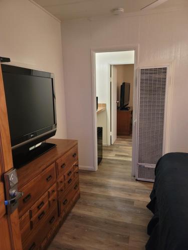a bedroom with a flat screen tv on a dresser at Oceana Boutique Hotel in San Clemente