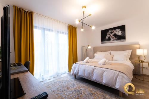a bedroom with a large bed with yellow curtains at Quibio Apart Terrace in Braşov