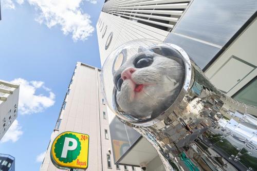 a statue of a mouse in front of a building at WeBase Hakata Hostel in Fukuoka