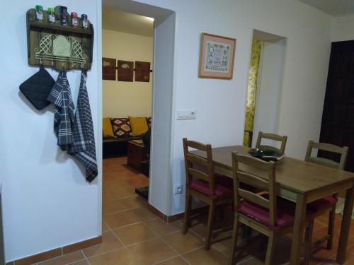 a dining room with a wooden table and chairs at Cals Nonos in Torrefeta