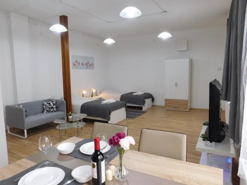 a room with a dining table and a living room at Apartments Mateo in Zagreb