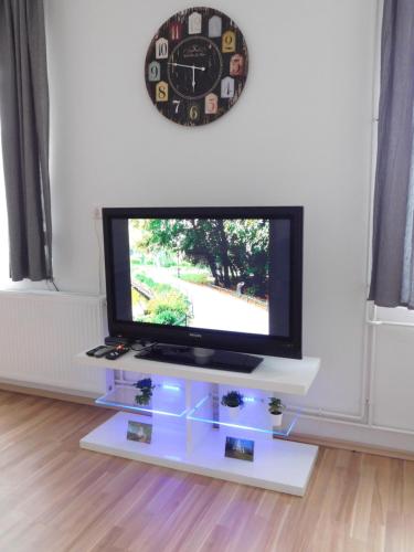 a flat screen tv on a stand in a living room at Apartments Mateo in Zagreb