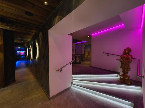 a room with purple lights on the walls at Alpen Appartements Lärchenhof in Lermoos