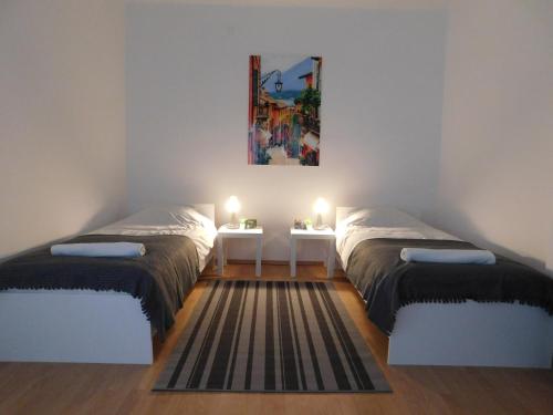 a room with two beds and a table with lights at Apartments Mateo in Zagreb