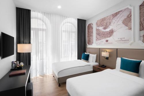 a hotel room with two beds and a map on the wall at Akka Suites Taksim-Special Class in Istanbul