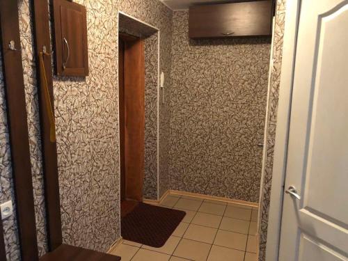 a bathroom with a walk in shower next to a wall at Kyiv daily rent Apartments on Bogdana Gavrilishina 10 in Kyiv