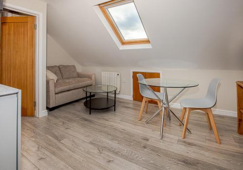 a living room with a table and a couch at Spacious New One Bed Flat in the Heart of Reading in Reading