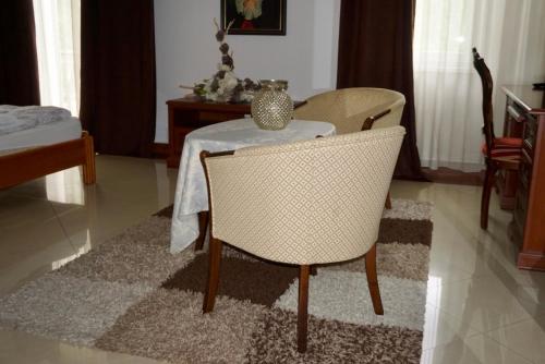 a dining room with a table and a table and chairs at Penzion Vegas in Partizánske