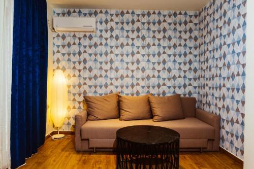 a living room with a couch and a table at Семеен хотел АРИЗОНА in Pavel Banya