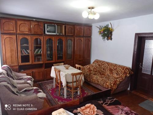 a living room with a table and a couch at Садиба Брусний in Mykulychyn