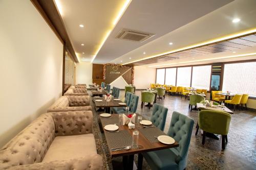 a restaurant with couches and tables and chairs at VIVANA in Dhanbād