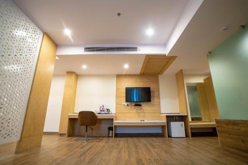 an office with a desk and a tv on a wall at VIVANA in Dhanbād