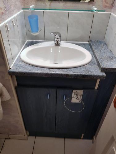 a white sink in a bathroom with a counter at Gîte Santenay les Bains in Saint-Sernin-du-Plain