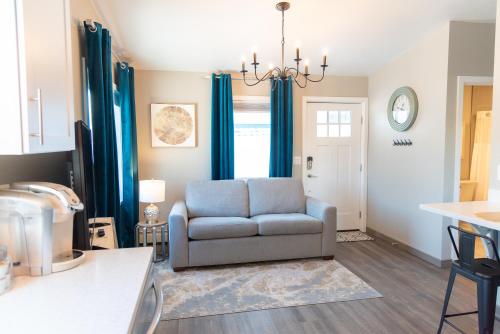 a living room with a couch and blue curtains at Colony Suites in Palmer
