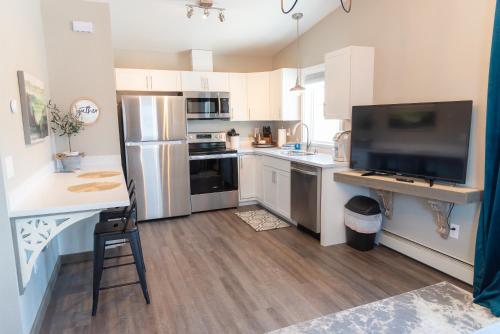 a kitchen with white cabinets and stainless steel appliances at Colony Suites in Palmer