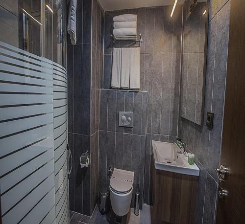 a bathroom with a toilet and a sink at Istanbul Airport Express Hotel in Arnavutköy
