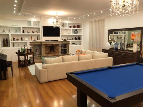 a living room with a couch and a pool table at SOLAR DA SERRA-GuestHouse in Mangualde