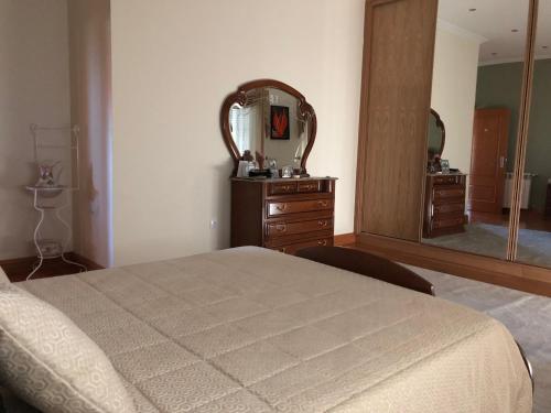 a bedroom with a bed and a large mirror at SOLAR DA SERRA-GuestHouse in Mangualde