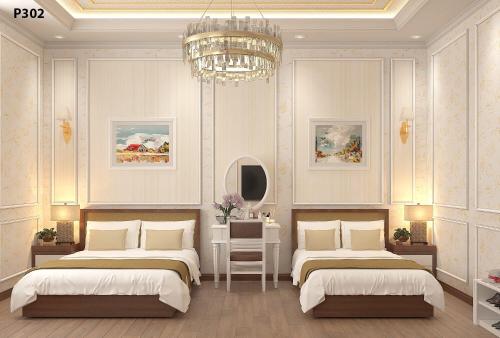 a bedroom with two beds and a chandelier at Halong Lavender Hotel in Ha Long