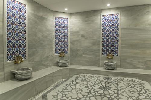 a bathroom with two toilets and stained glass windows at Le Monde Beach Resort & Spa in İzmir