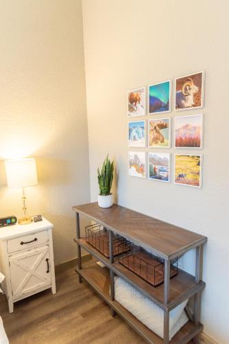 a room with a table with a plant on a wall at Colony Suites in Palmer