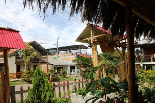 a group of houses with a fence and trees at Cabañas Guacari San Agustín huila in San Agustín