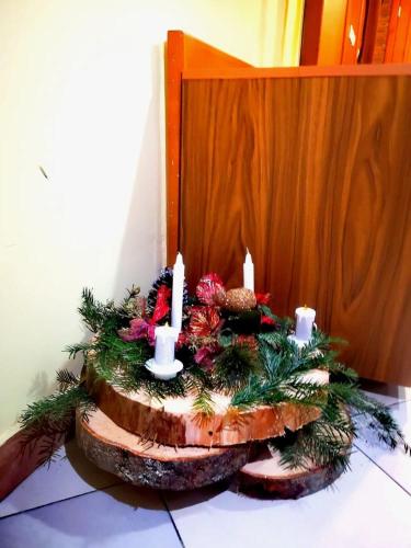 a christmas centerpiece with candles on a table at Family Hotel LILI in Bansko