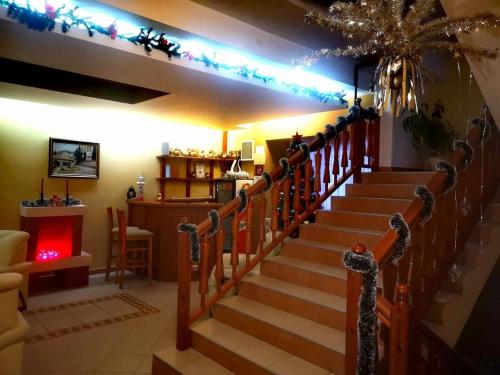 a set of stairs in a living room with lights at Family Hotel LILI in Bansko