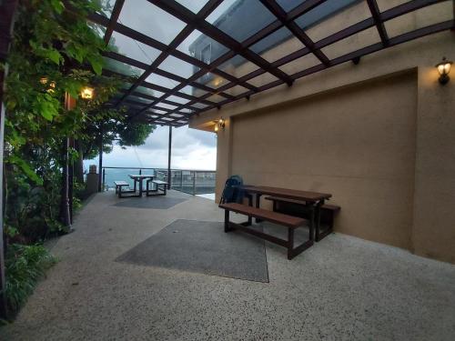 a patio with benches and a view of the ocean at Dosun B&B in Jiufen