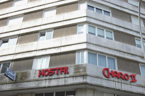 a building with a hospital sign on the side of it at Hostal Charo II in Santiago de Compostela