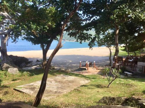 a view of the ocean from a hill with trees at Khanom Hill Resort in Khanom