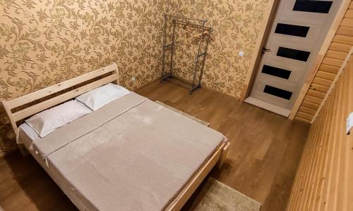 an empty bed in a room with a door at SOKIL HOUSE in Slavske