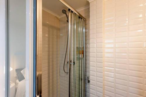 a shower with a glass door in a bathroom at Charming Studio in Mouraria in Lisbon