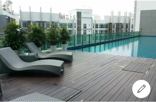 a pool on the roof of a building at Central residence in Kuala Lumpur