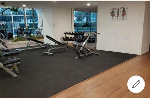 a gym with rows of exercise equipment in a room at Central residence in Kuala Lumpur