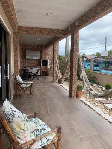 a living room with a couch on a patio at Pousada cantinho do Descanso in Penha