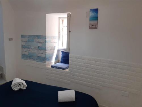 a room with a blue chair and a window at Emidio House in Termini