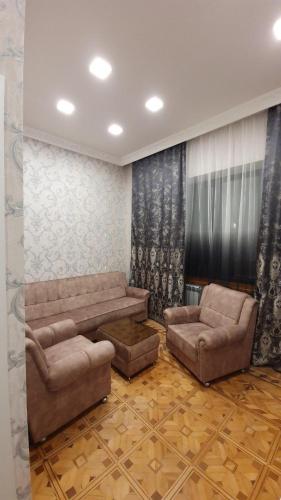 a living room with two brown couches at JINJOTEL Gyumri in Gyumri