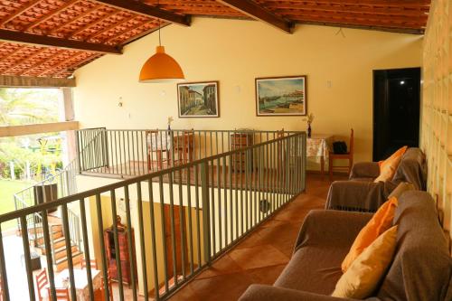 a living room with two couches and a staircase at Pousada Vila do Mar in São Luís